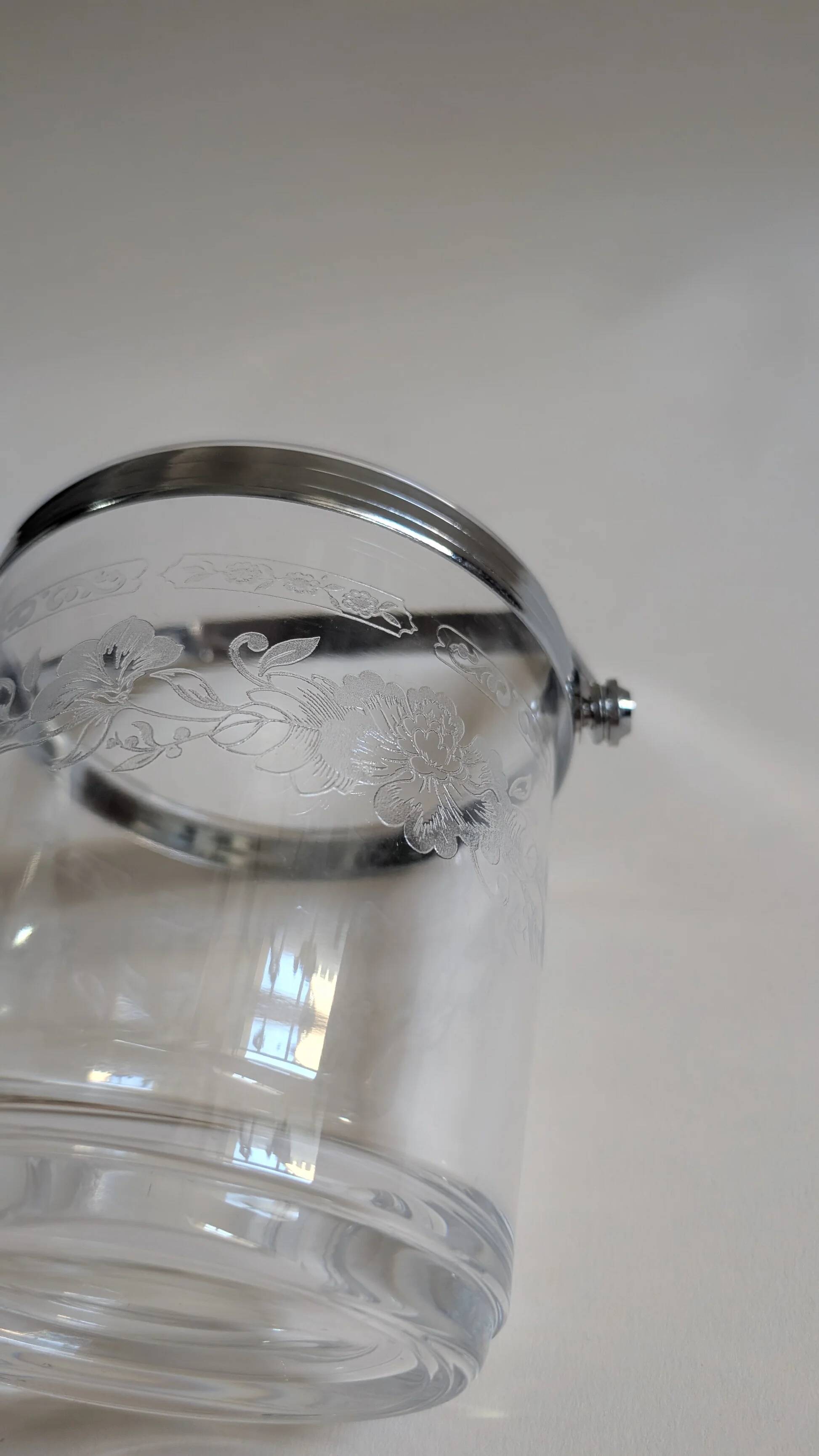 Clear glass ice bucket with an etched floral design