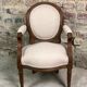 Louis XVI style children's armchair in carved walnut and beige antique upholstery