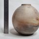 Round ceramic vase with raw finish, smoked firing, signed, late 20th century, 11 cm.