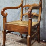 Empire armchair in solid walnut with woven straw seat.