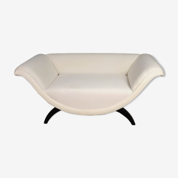 Upholstered curved shaped sofa with black legs