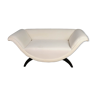 Upholstered curved shaped sofa with black legs