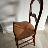 Antique wooden chair with woven straw seat – rustic style