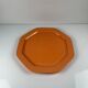 Octagonal plate in salmon pink, iron earth, Pagnossin, Italy, 20th century.