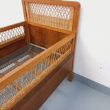 Vintage oak and rattan baby cot from the 1960s.