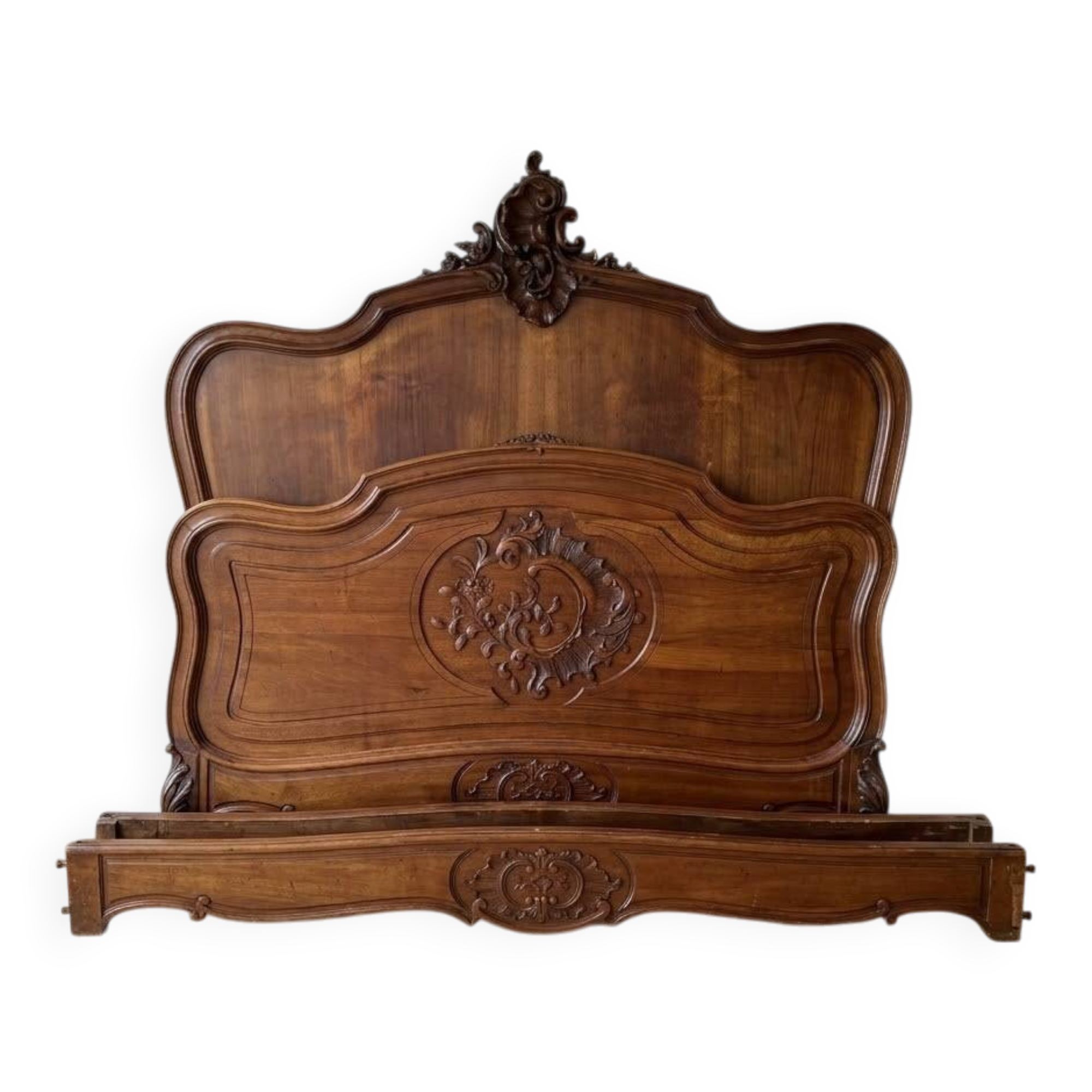Antique carved bed in Louis XV style made of wood.