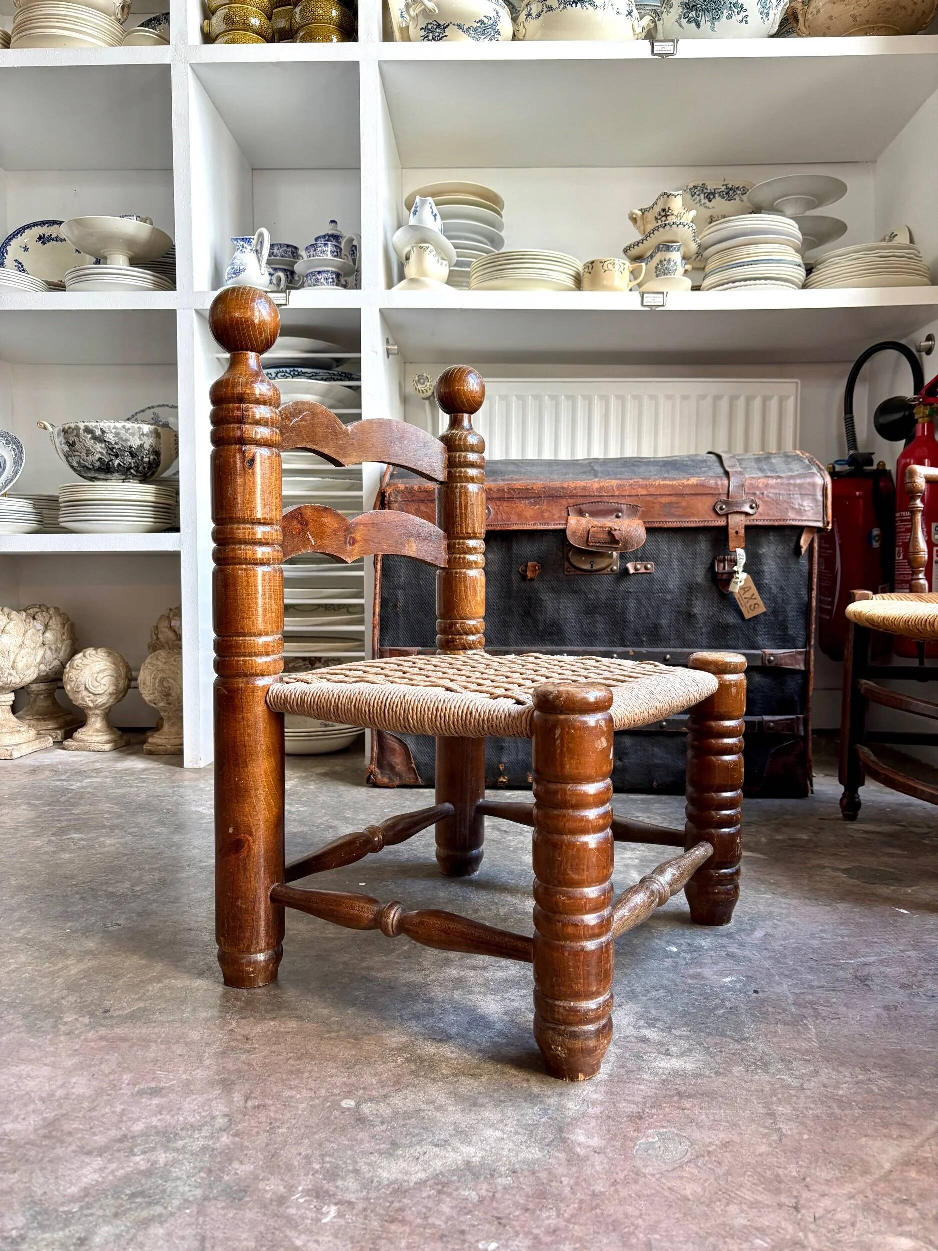 Low chair in dark wood and woven Danish cord attributed to Charles Dudouyt.