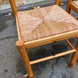 2 straw-seated chairs in light-colored solid wood