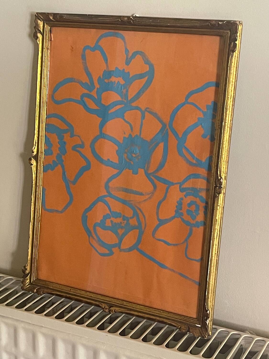 Gouache painting of blue flowers on an orange background