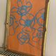 Gouache painting of blue flowers on an orange background