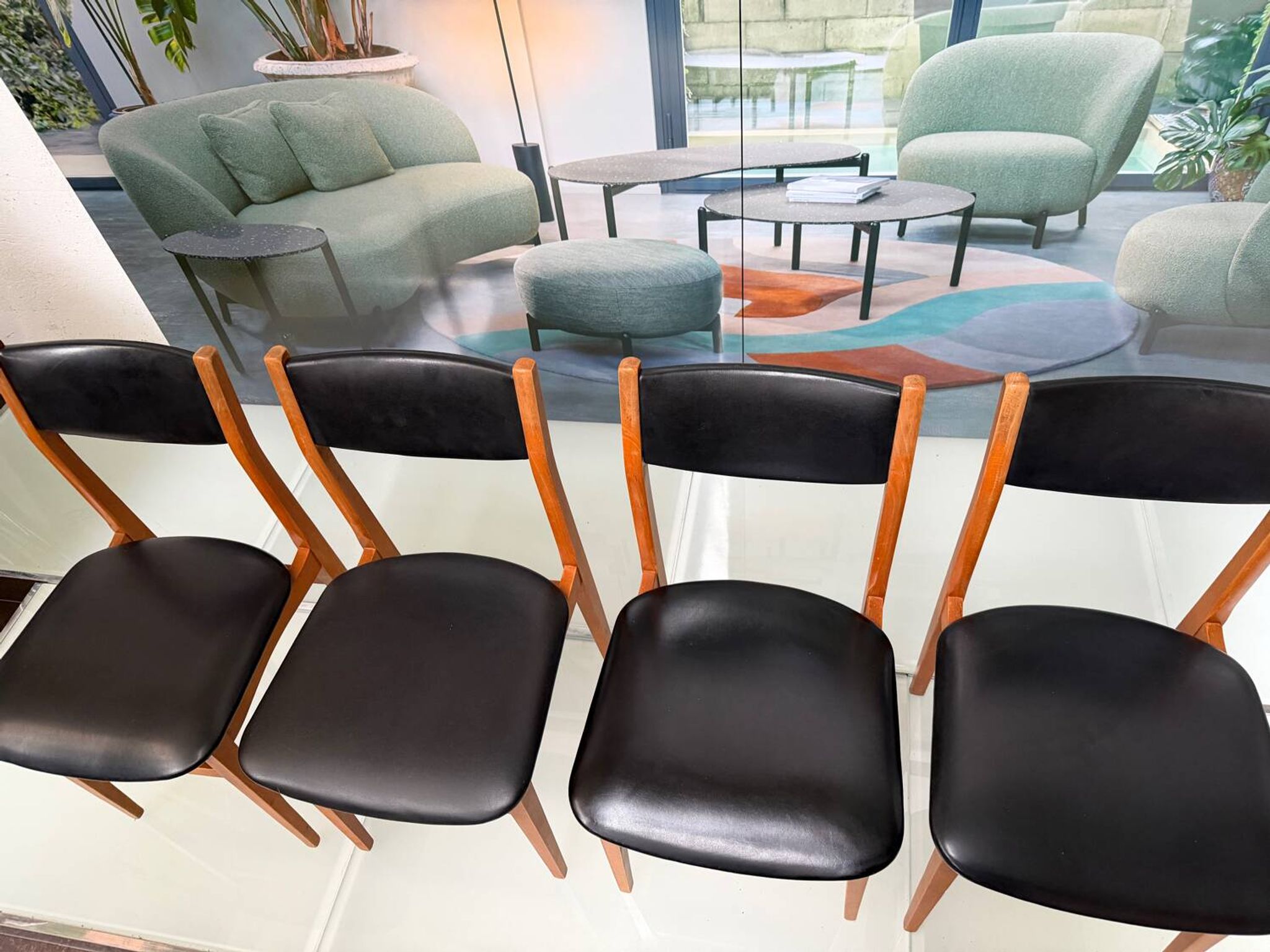 4 Scandinavian chairs in teak and black faux leather.