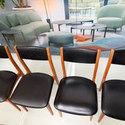 4 Scandinavian chairs in teak and black faux leather.
