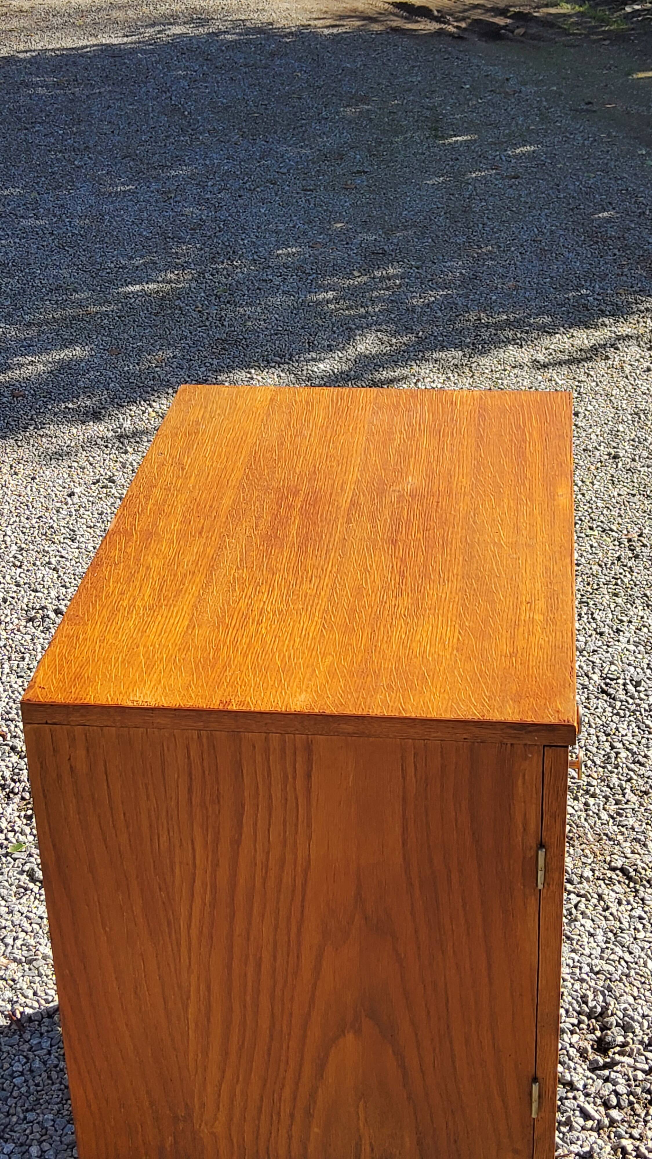 Vintage golden oak sideboard with conical legs from the 1950s