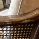 Vintage wooden armchair with rattan weaving.