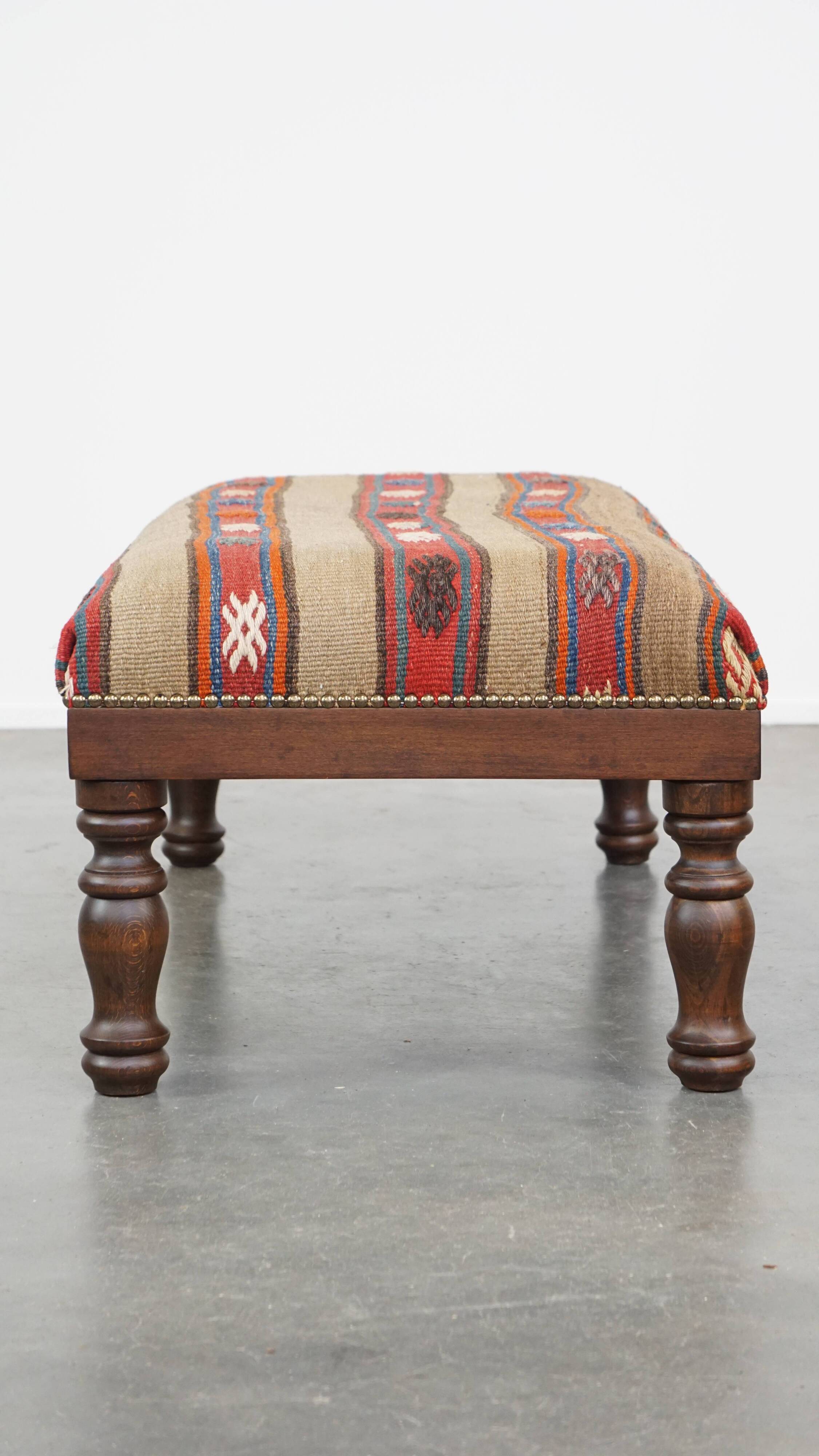 Oriental pouf upholstered in an antique kilim
