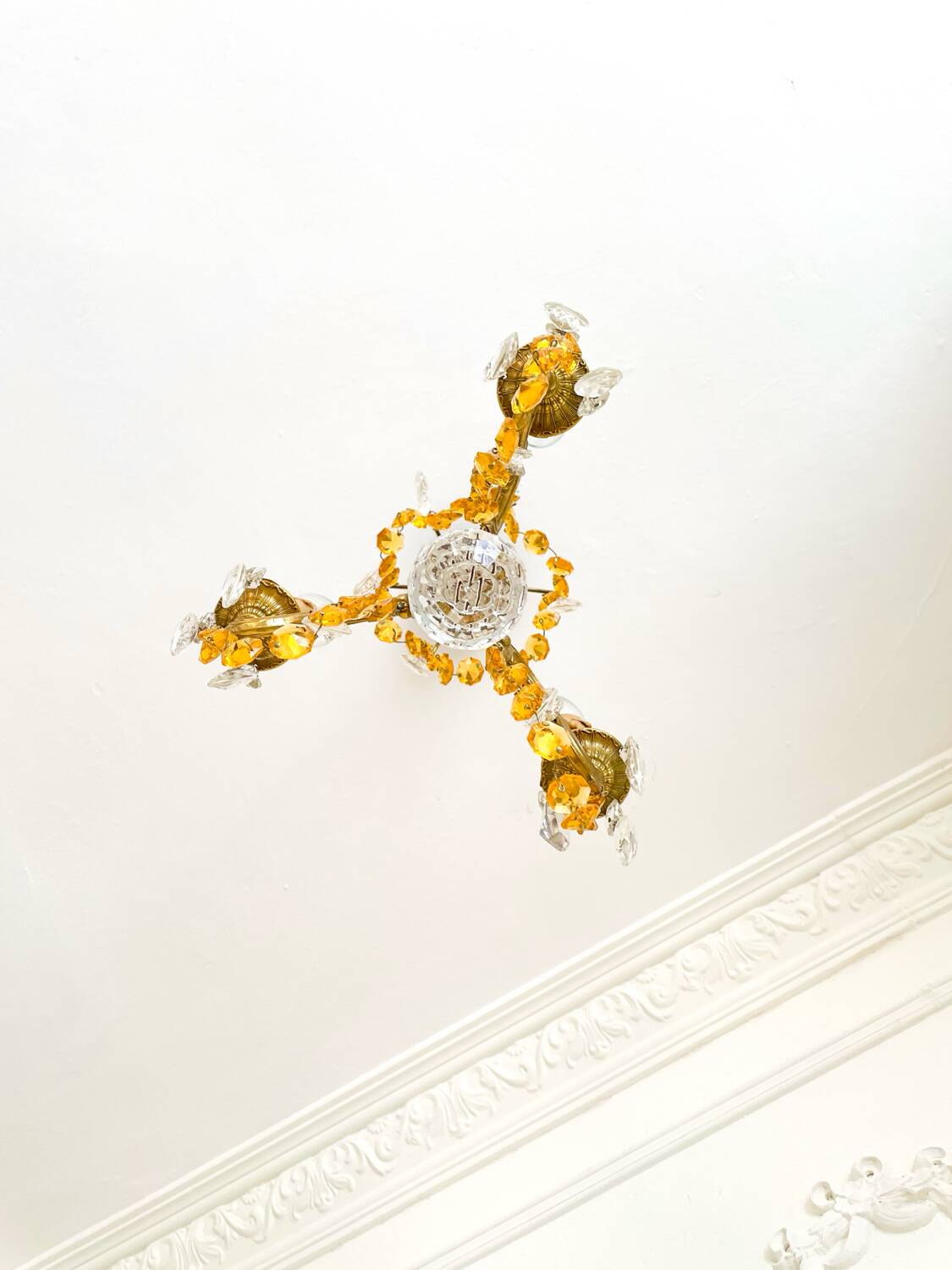 Small vintage brass chandelier with amber crystal pendants.