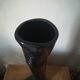 Black earthenware vase gloved hand