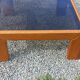 Coffee table from Regain in solid elm with a smoked glass top.