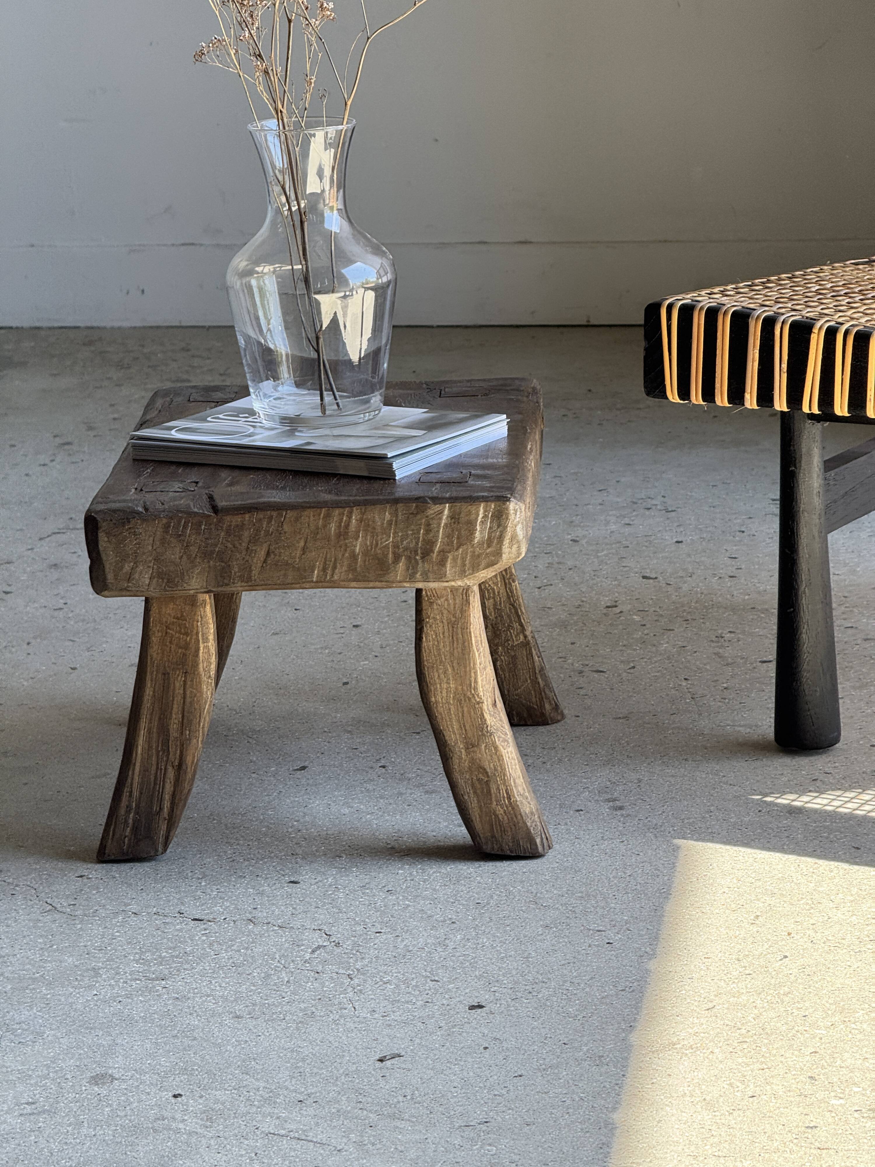 Small stool, rectangular solid teak side table with curved legs.