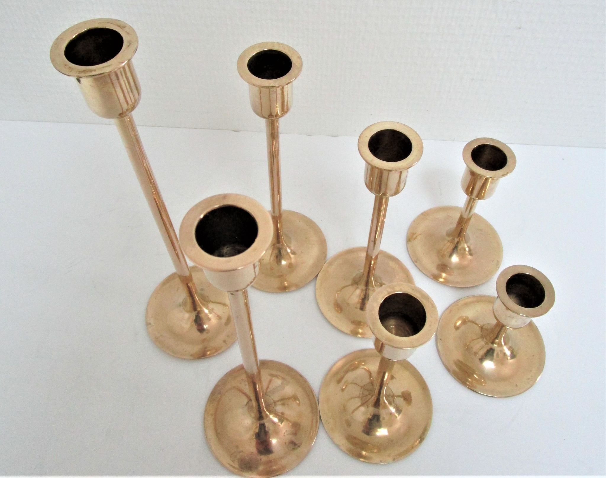 Series of seven candle holders solid brass