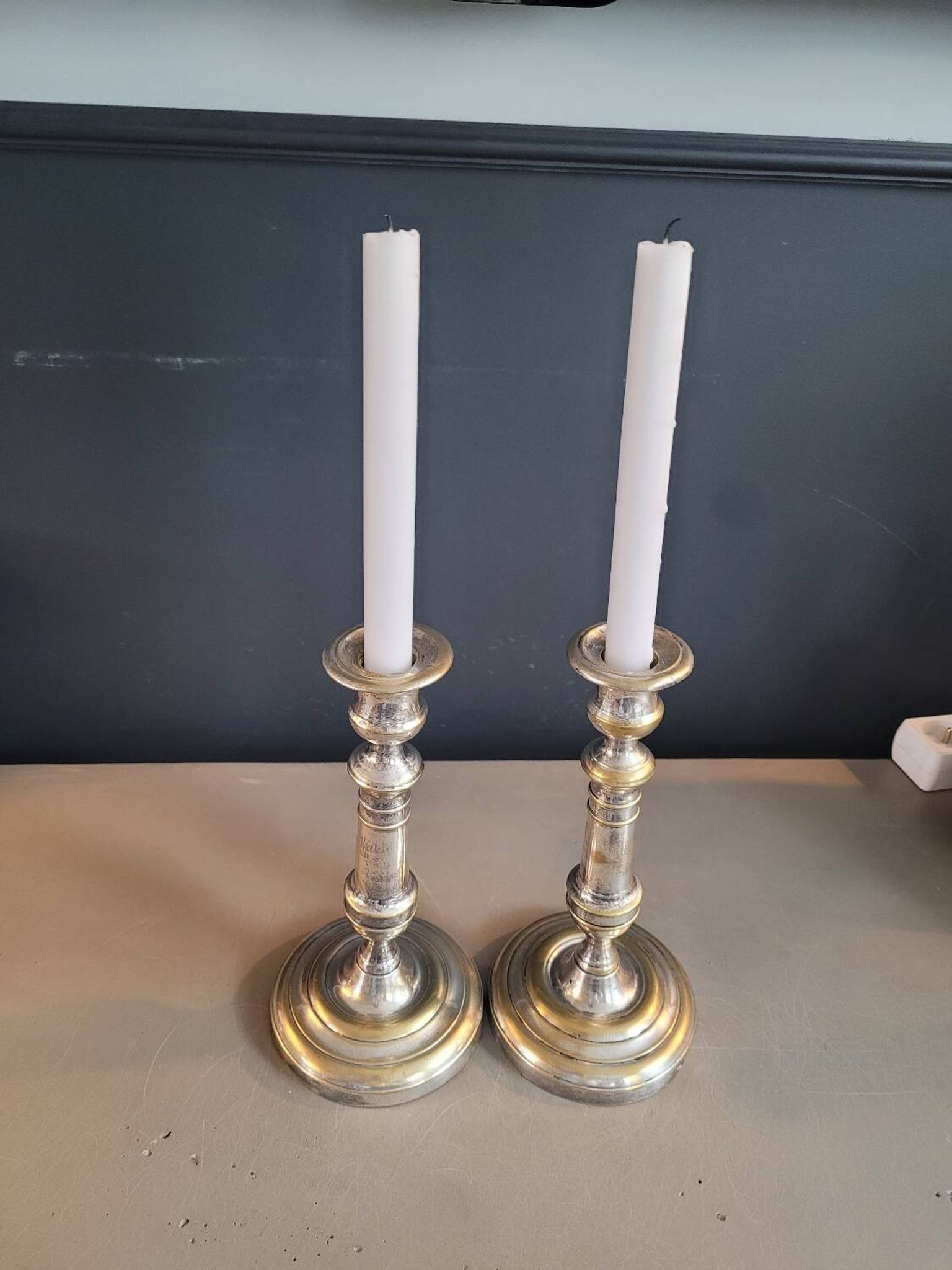 Pair of antique silver-plated brass candlesticks
