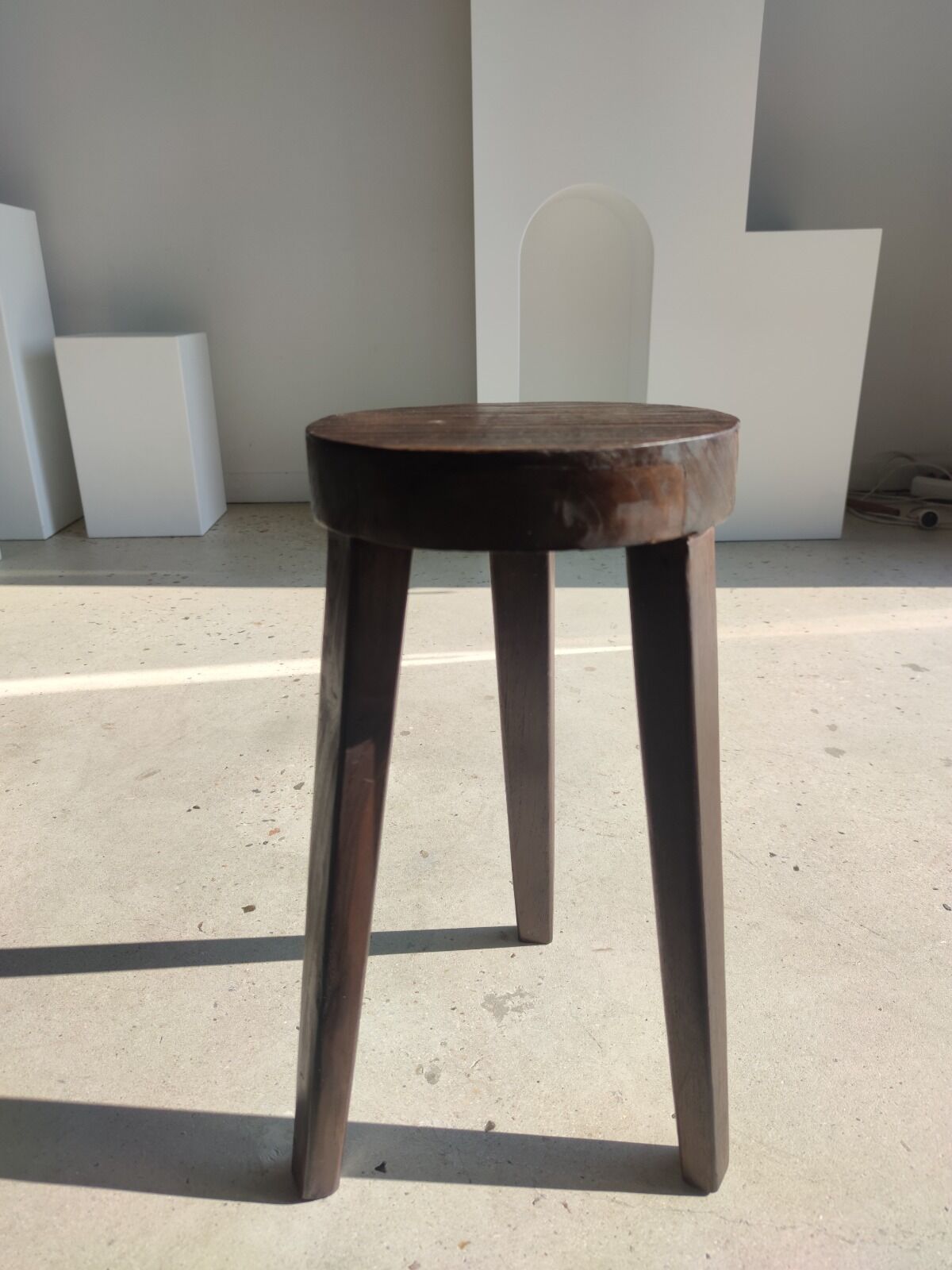 Small high tripod stool in brown solid wood