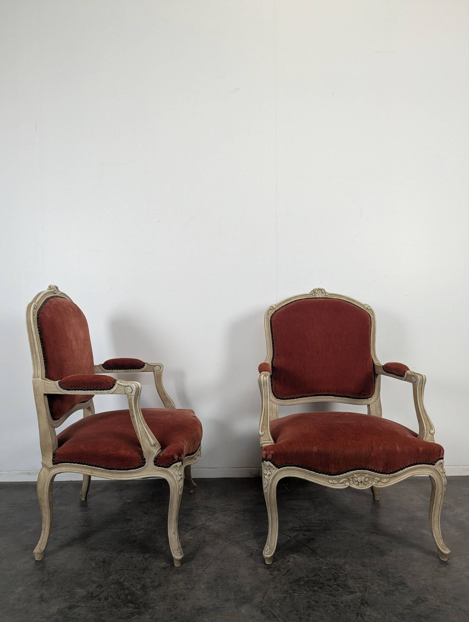 Pair of red cabriolet armchairs in Louis XV style