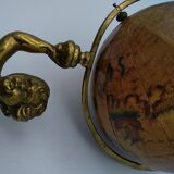 Cherub or putti carrying a globe
