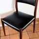 Four antique Scandinavian-style chairs made of solid wood and faux leather.