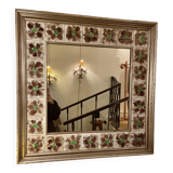 Large square ceramic mirror with floral decoration.