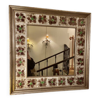 Large square ceramic mirror with floral decoration.