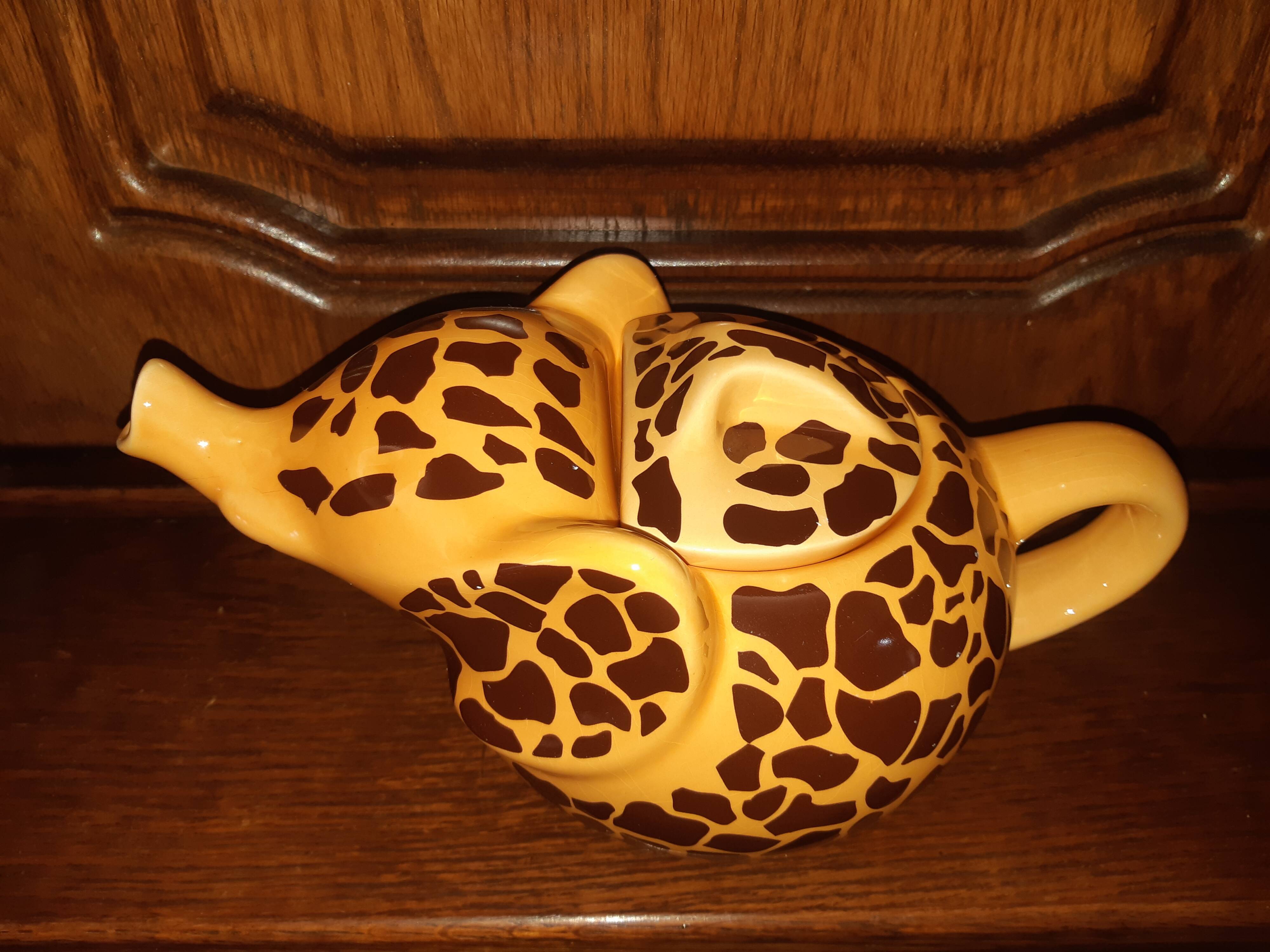 Elephant teapot decorated with giraffe cheetah, signed by the brand elephant 1896