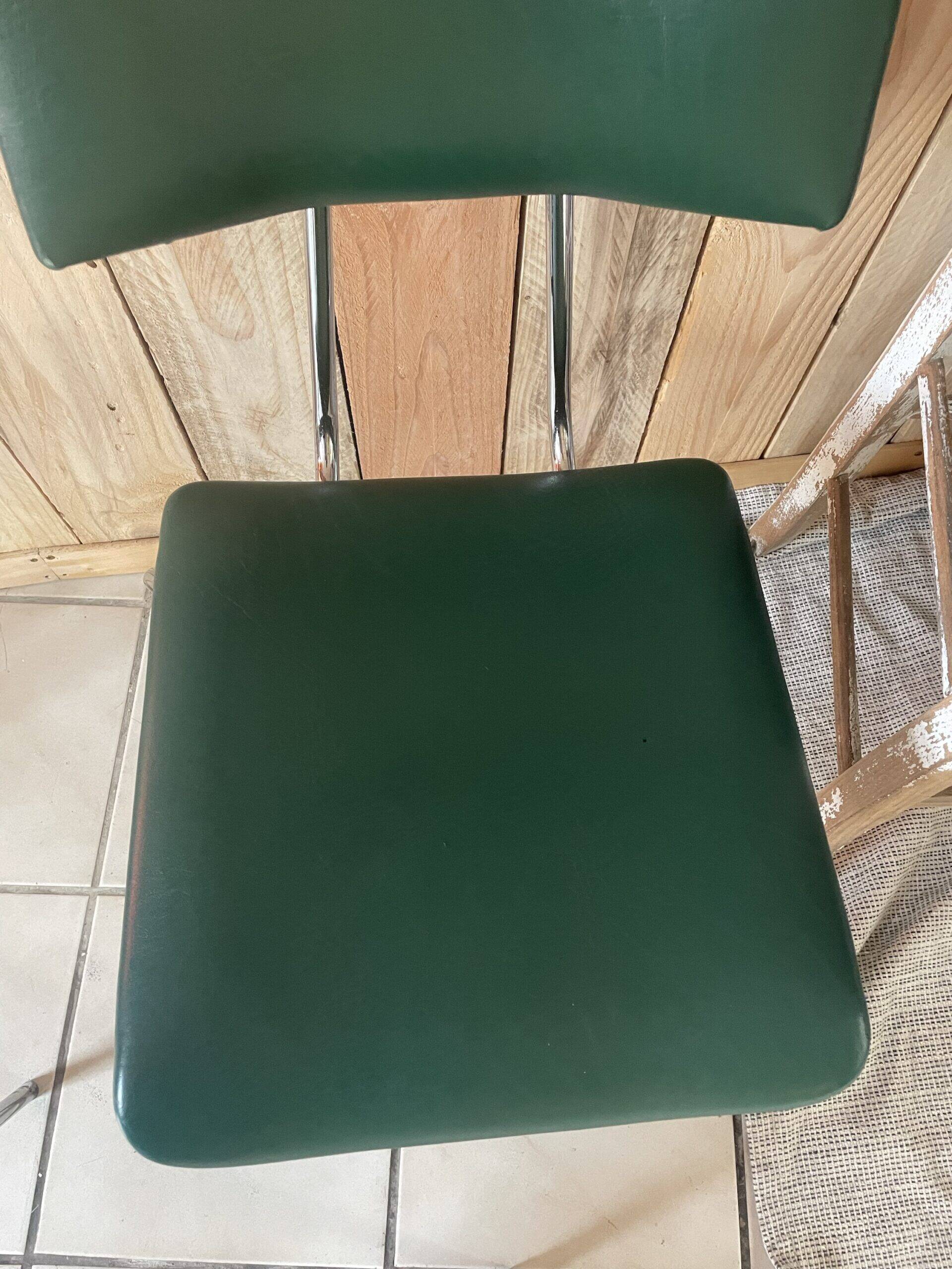 Pair of green faux leather chairs