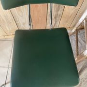 Pair of green faux leather chairs