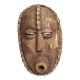 Decorative African mask in carved wood and cowrie shells, Baoulé style, 34 cm