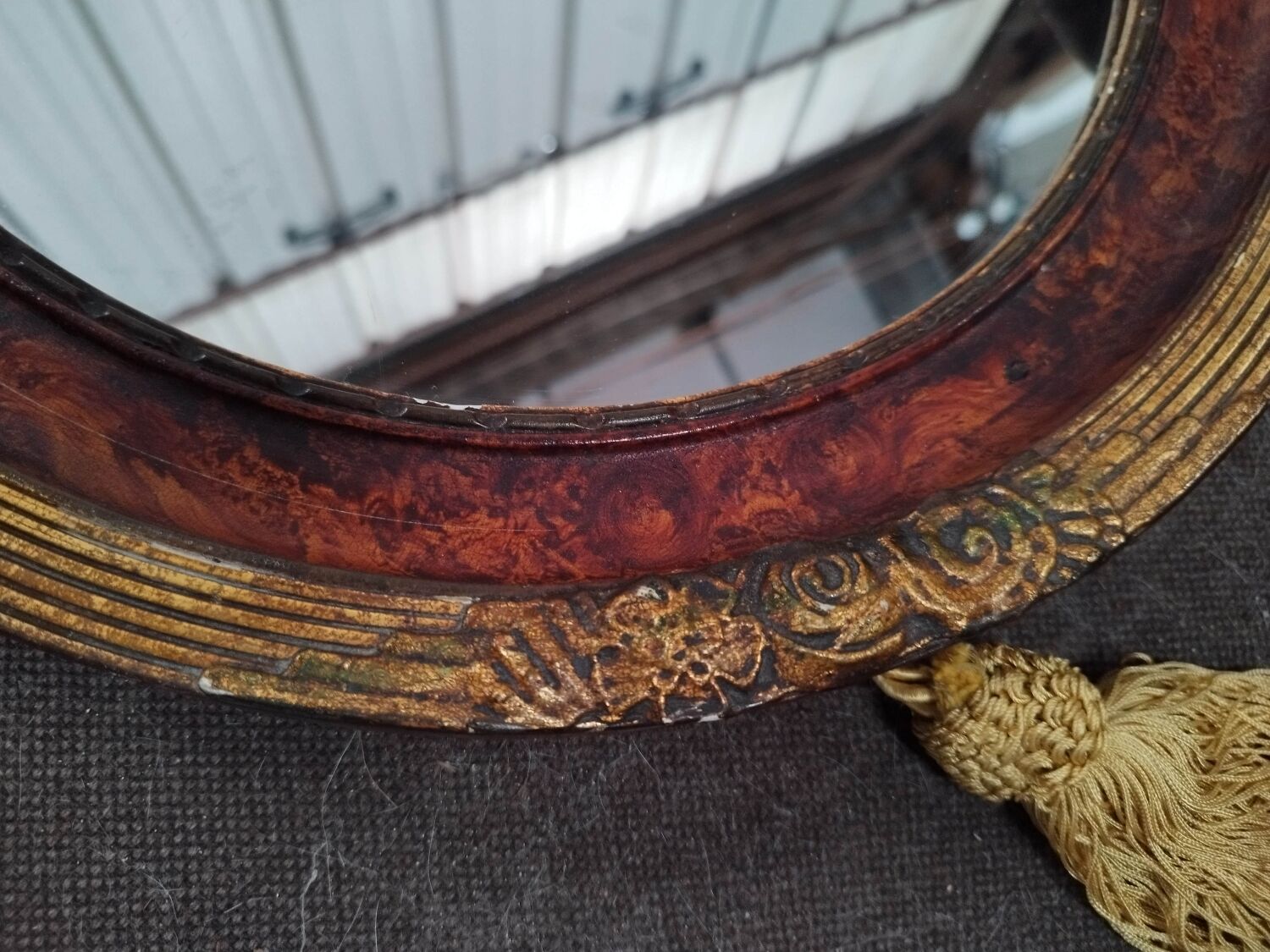 Golden oval art deco mirror