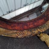 Golden oval art deco mirror