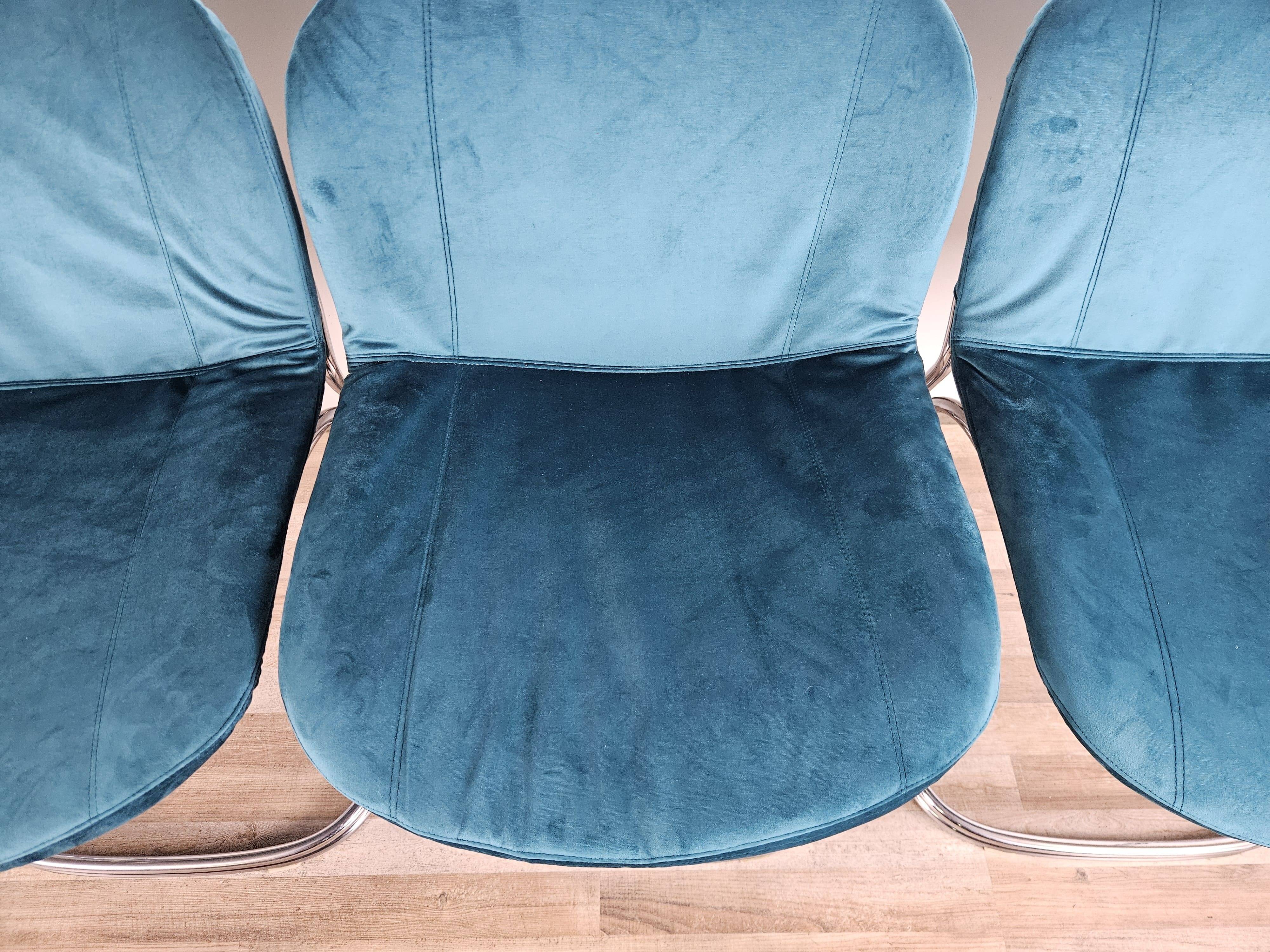 Four 1970s tubular chairs upholstered in blue velvet