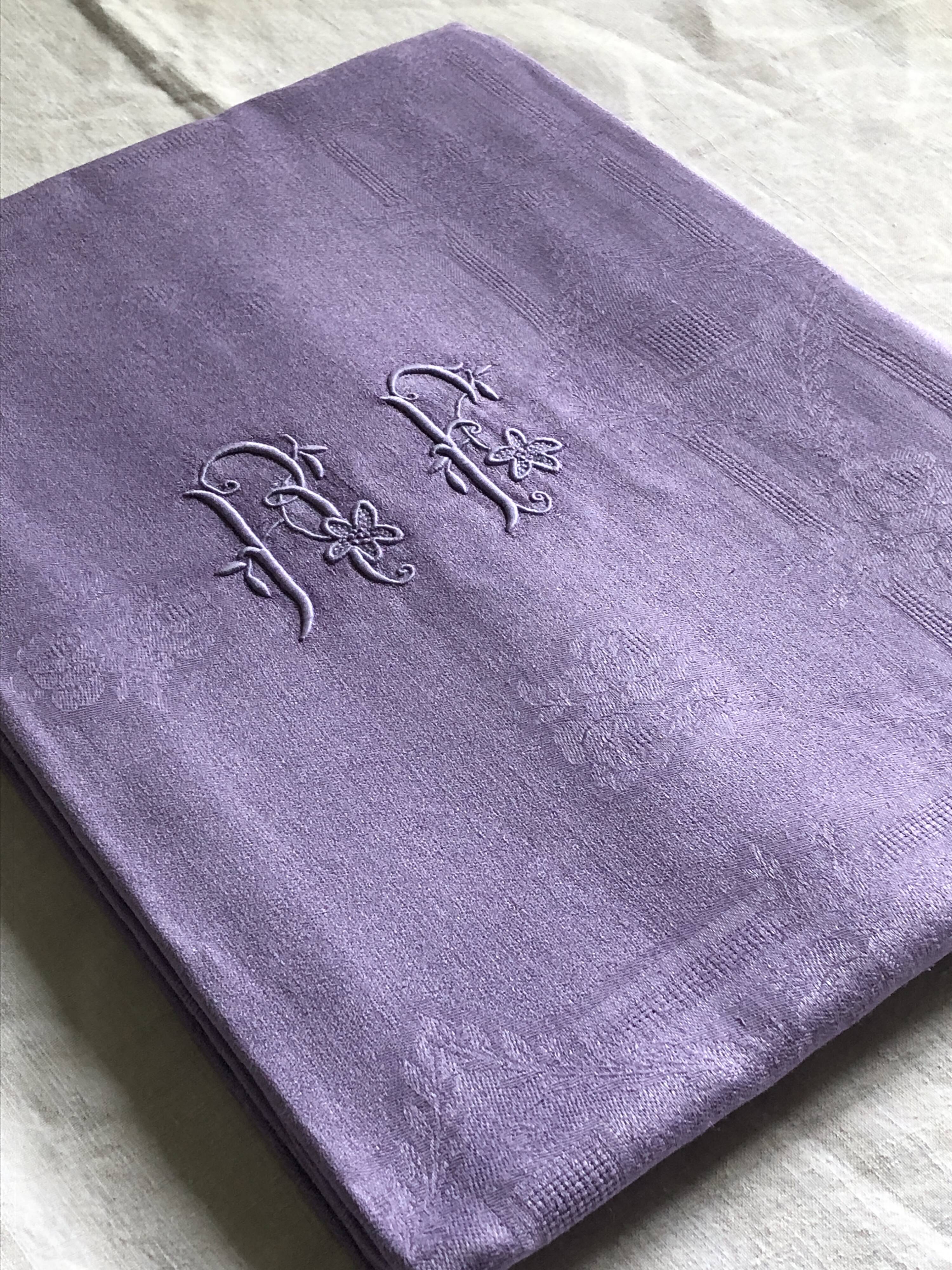 Old damask tablecloth in linen and purple silk