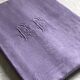 Old damask tablecloth in linen and purple silk