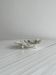Leaf-shaped metal pocket tray in silver-white.