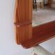 Wall mirror with a solid pine frame, integrated shelf.