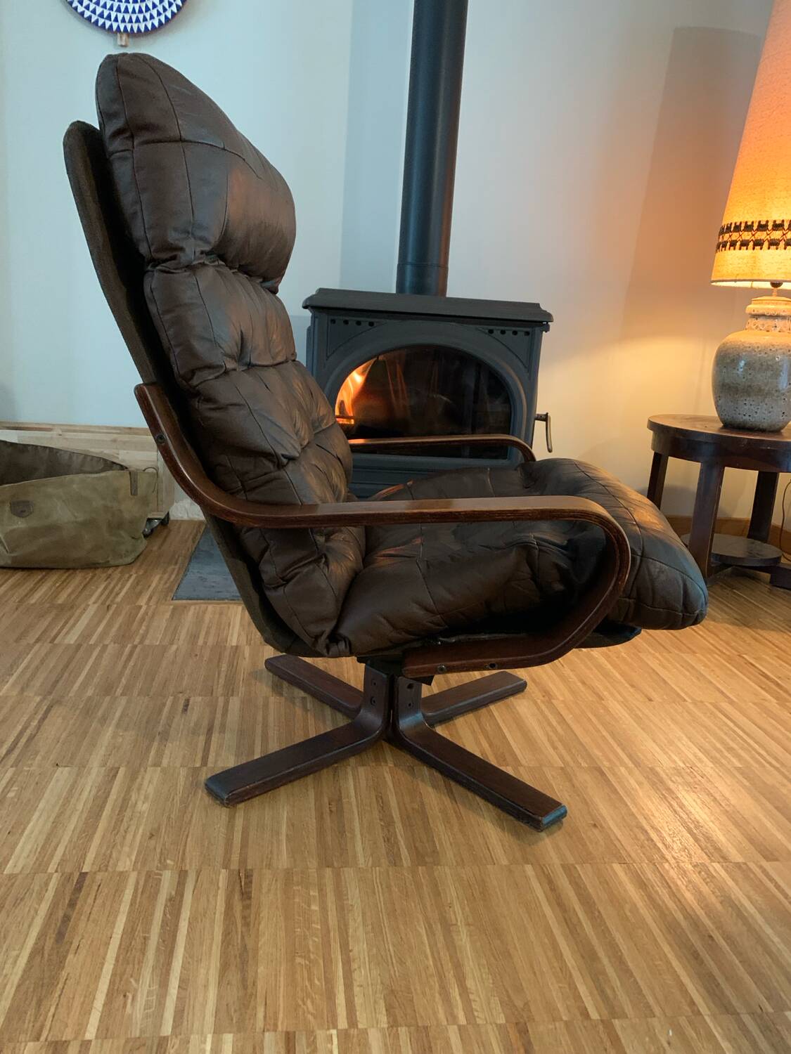 Vintage leather armchair with wooden armrests