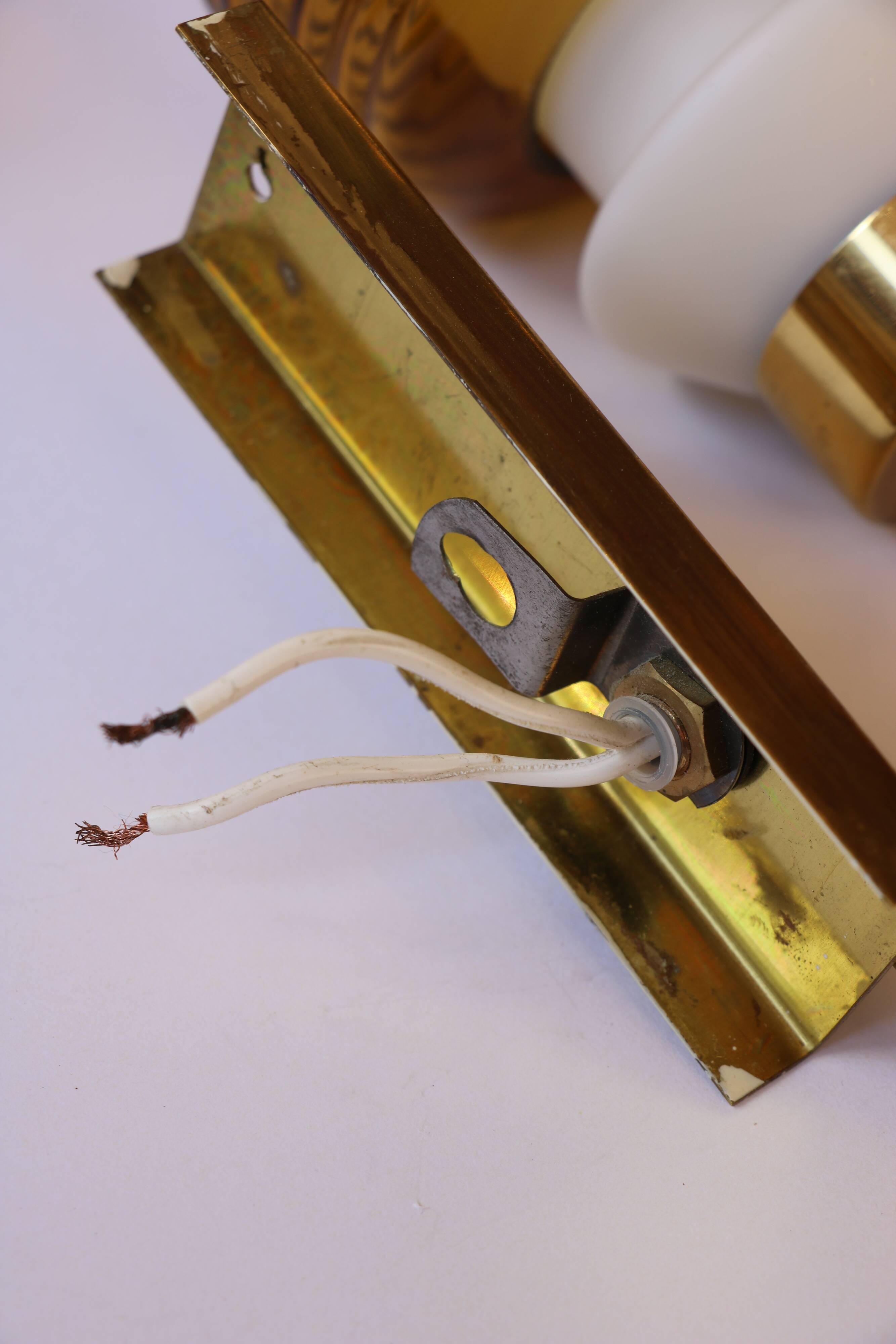 Pair of Scandinavian wall sconces, brass, opal glass and amber glass.