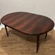 Extendable dining table in Rio rosewood.