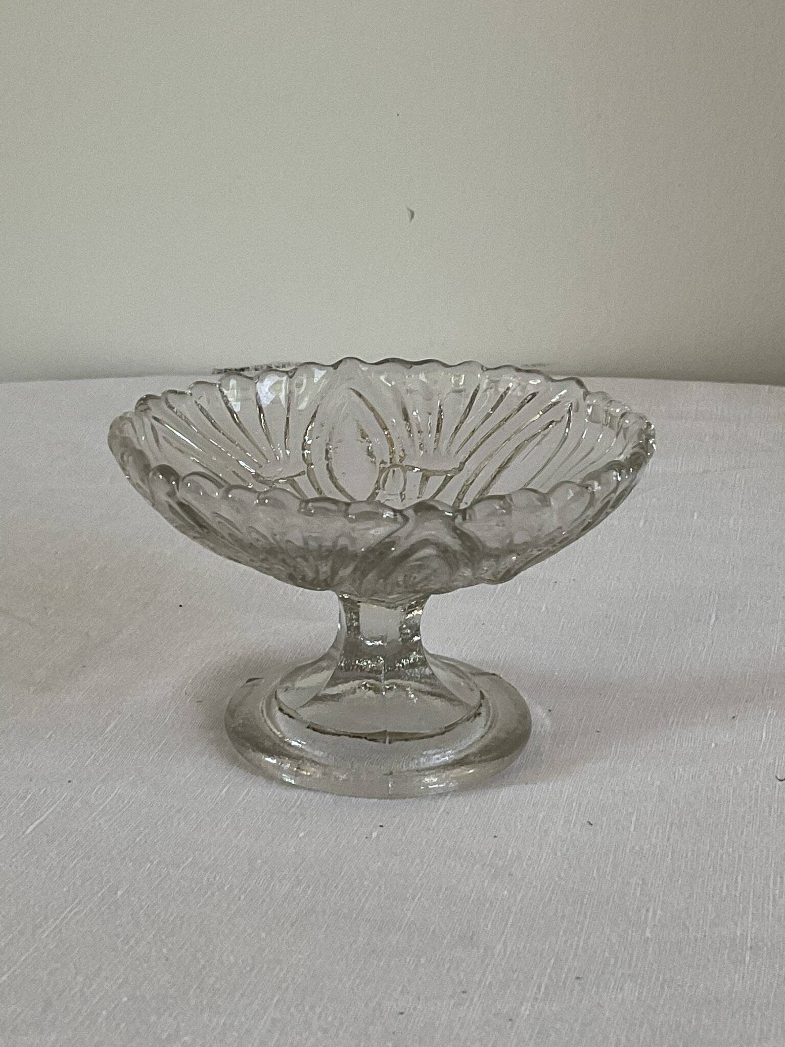 Small vintage footed bowl, made of clear moulded glass.