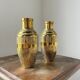 Duo of embossed brass vases