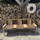 Baumann bench with wooden frame and faux leather seat.