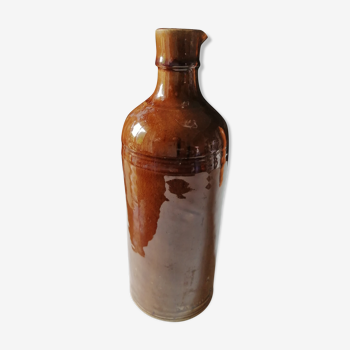 Old bottle in varnished ground.