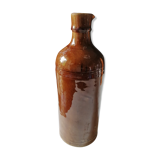 Old bottle in varnished ground.